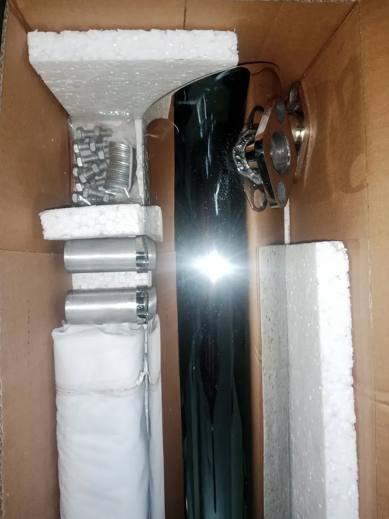 Opposite side view of a chrome exhaust and wrapped fittings inside its box
