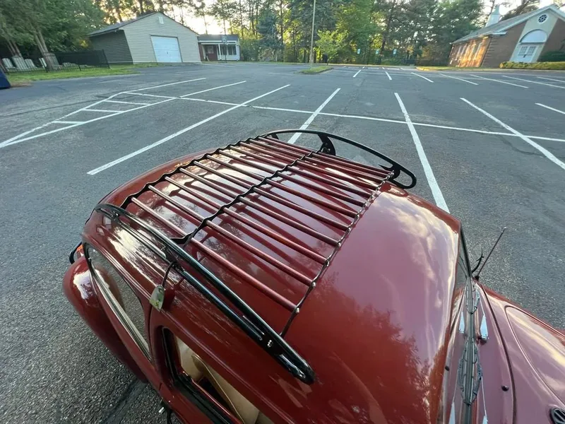 High view across the red slats and black frame of a fitted Beetle roof rack