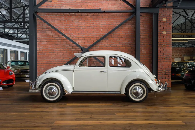 White Volkswagen Beetle in side profile indoors