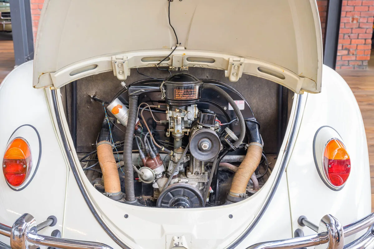 Open rear engine bay of a white Volkswagen Beetle