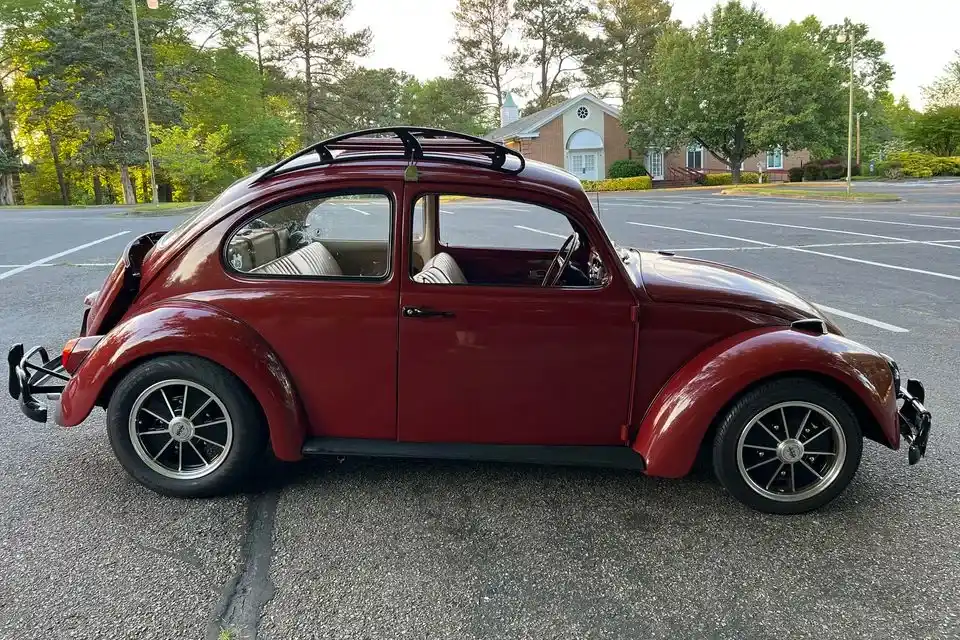 Red VW Beetle side profile with speed roof rack installed